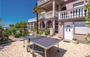 a ping pong table in front of a house at 6 Bedroom Beautiful Home In Crikvenica in Crikvenica +64 photos