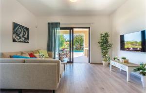a living room with a couch and a table at Four-Bedroom Holiday Home In Premantura in Premantura