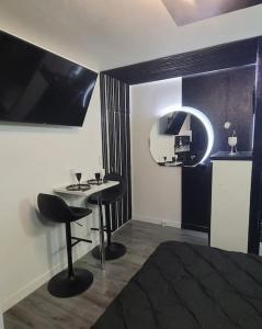 a room with a table and two chairs in a room at Studio Black and White in Le Mans +2 photos