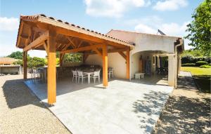 a pavilion with a table and chairs on a patio at Beautiful Home In Prades-Sur-Vernazobre in Prades-sur-Vernazobre