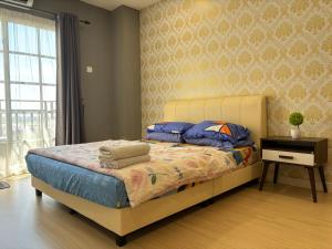 Postel nebo postele na pokoji v ubytování KF Homestay Premium Suite