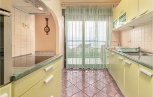 a kitchen with a sink and a window at Cozy Apartment In Crikvenica in Crikvenica