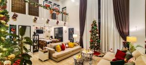 a living room decorated for christmas with a christmas tree at Adora's Place in Coron