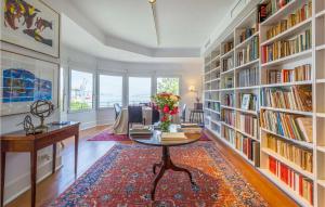 a library with a table and bookshelves with books at Casa Hernán in Cádiz