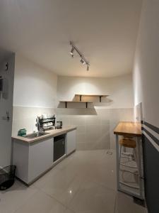 a kitchen with a sink and a counter in it at FAHomestay in Kota Kinabalu