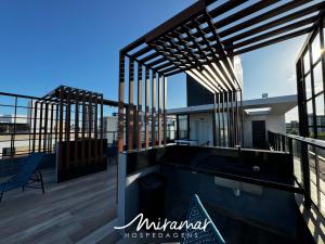 a deck with a hot tub on top of a building at Flat No Bessa com Varanda Gourmet in João Pessoa
