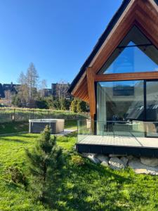 a modern house with a glass facade at Górski Domek Zakopane in Kościelisko