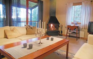 a living room with a couch and a table with candles at Gorgeous Home In Gislaved With Wifi in Våthult