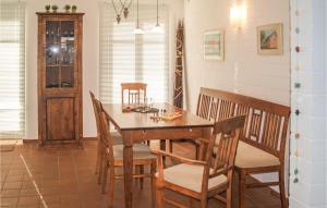a dining room with a wooden table and chairs at 2 Bedroom Amazing Apartment In Koserow in Ostseebad Koserow