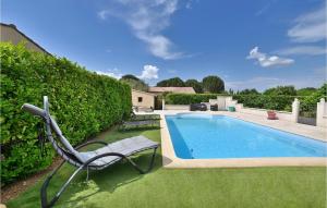 a swimming pool with a chair next to a hedge at Cozy Home In Malataverne in Malataverne +15 photos