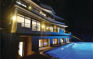 a large building with a swimming pool at night at Lovely Home In Santa Susanna With Wifi in Santa Susanna