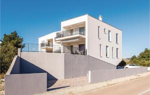 a white building with a balcony on the side of it at Three-Bedroom Holiday Home In Brodarica in Brodarica