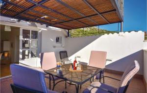 a patio with a table and chairs on a patio at Holiday Home Drmate Milicica Vi in Hvar