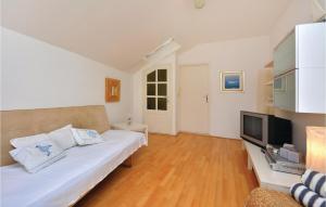 a living room with a couch and a television at Holiday Home Drmate Milicica Vi in Hvar +24 photos
