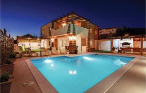 a large swimming pool in front of a house at Gorgeous Home In Solin in Solin