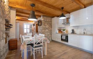 a kitchen with a table and chairs in a room at Awesome Home In Glavina Donja in Donja Glavina