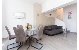 a living room with a table and a couch at Three-Bedroom Holiday Home In Suhi Potok in Jesenice