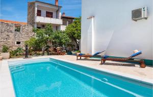 a swimming pool with two lounge chairs next to a building at Villa La Maison Adriatique in Zadar +52 photos