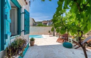 a patio with a swimming pool and a house at Villa La Maison Adriatique in Zadar
