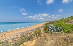 a view of the beach from a bluff at Gorgeous Home In Trabia With Wifi in Trabia +27 photos