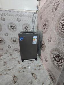 a small refrigerator in a bathroom with a wall at Appartement a Louer Laayoune in Laayoune