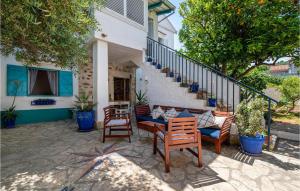 a patio with a table and chairs and stairs at Villa La Maison Adriatique in Zadar