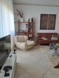 a living room with a couch and a television at 2 Giugno House in Bari