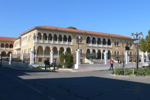 a large building with people walking in front of it at Alkinoos Studio in Nicosia