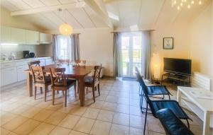 a kitchen and dining room with a table and chairs at Zeepolder Ref 230 in De Haan