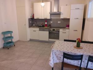 a kitchen with a table and a table and a table and a table at Studio tout confort in Labergement-Sainte-Marie +2 photos