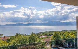 a view of the water from the balcony of a house at Beautiful Home In Kostrena in Kostrena