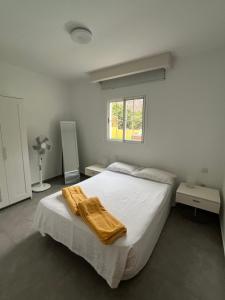 a bedroom with a bed with a yellow blanket on it at SUNNY CARMELITO DELUXE in Mogán
