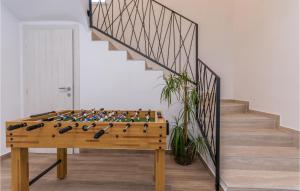 a game of chess on a table in front of a staircase at 4 Bedroom Lovely Home In Donje Rastane in Donje Raštane