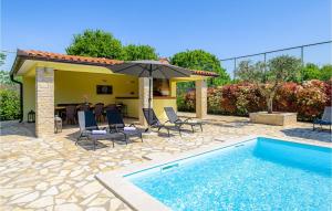 a patio with a pool and chairs and an umbrella at 3 Bedroom Amazing Home In Smoljanci in Smoljanci