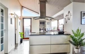 a kitchen with a large island with a stove at Holiday Home Arvidvej Hvide Sande Denm in Bjerregård