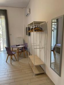 a room with a shelf and a table and a mirror at Sunshine Rooms in Cava deʼ Tirreni