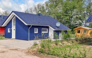 a blue and white house with at Cozy Home In Krems Iiwarderbrück in Göls +28 photos