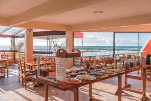 a breakfast buffet on the top of a cruise ship at Ferrujão Pousada e Restaurante in Garopaba