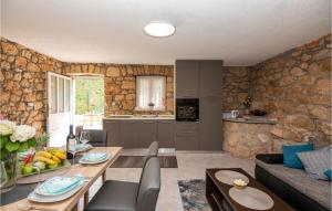 a kitchen and living room with a table and chairs at Lovely Home In Runovic in Garci