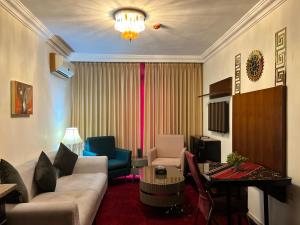 a living room with a couch and a table at Sama Paris Plaza Hotel in Amman
