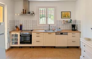 a kitchen with a sink and a stove at Cozy Home In Salernes With Wifi in Salernes