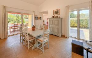 a dining room with a white table and chairs at Cozy Home In Salernes With Wifi in Salernes +19 photos