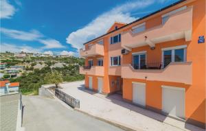 an orange house with a balcony on a hill at Cozy Apartment In Sevid With Wifi in Sevid