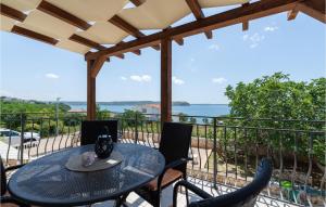 a table and chairs on a balcony with a view of the ocean at Holiday Home Rtina 24 in Rtina