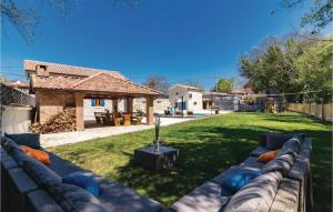 a backyard with a blue couch in the yard at Gorgeous Home In Bibici With Sauna in Bibići
