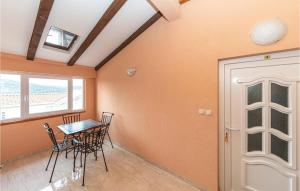 a dining room with a table and chairs and a door at Cozy Apartment In Sevid With Wifi in Sevid