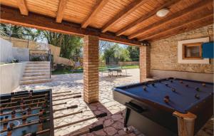 a patio with a pool table and a wooden roof at Gorgeous Home In Bibici With Sauna in Bibići
