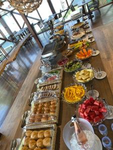 a long table with many plates of food on it at Coconut's Maresias Hotel in Maresias