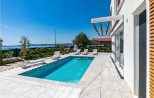 a swimming pool on the side of a house at Amazing Home In Kastel Gomilica in Kaštela