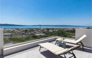 a balcony with two chairs and a table and a view at Amazing Home In Kastel Gomilica in Kaštela